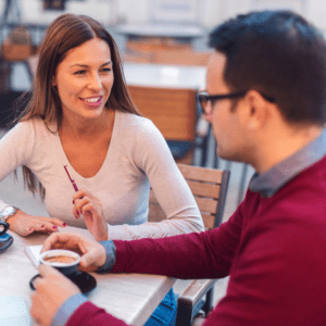 Woman and man talking over coffee