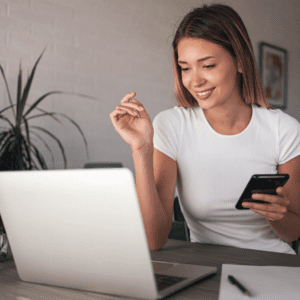 Woman checking a phone and laptop