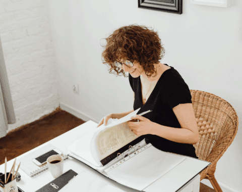 Woman sat at desk table doing paperwork